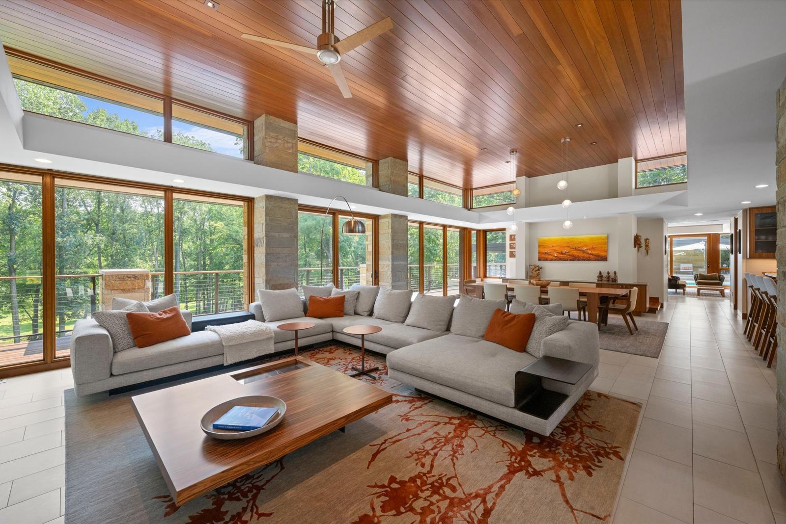 Sunlit great room with walls of windows at 4220 Renshaw Run, marketed by the Luxion Home Team