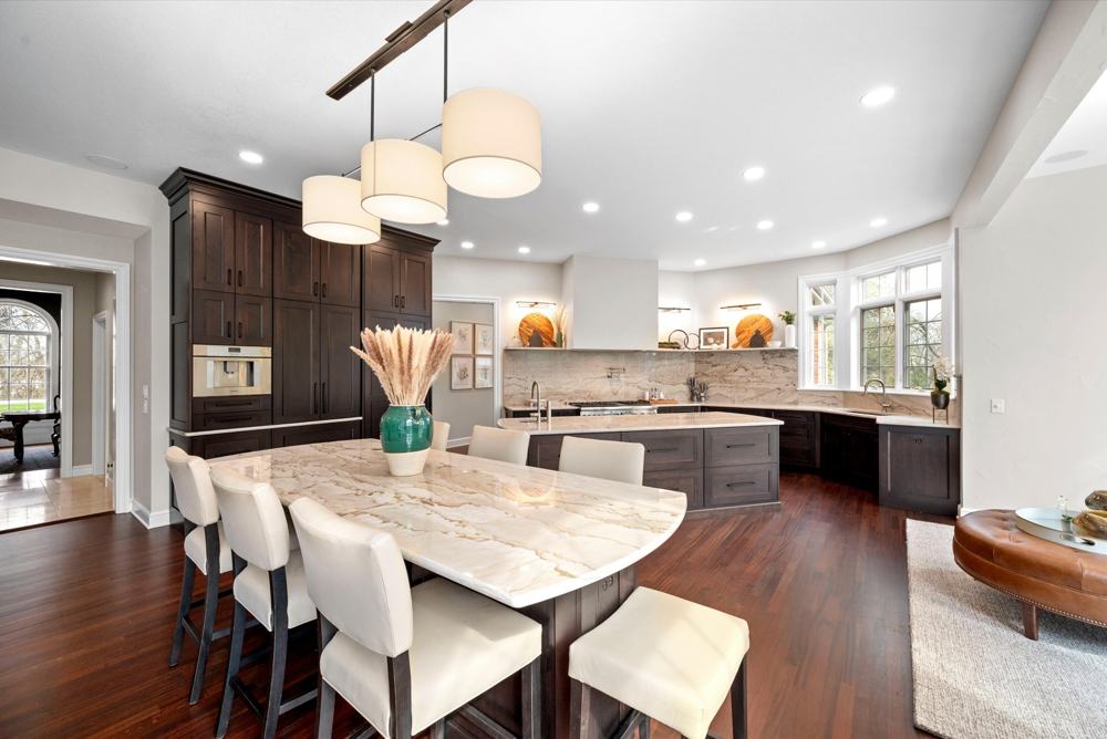 Kitchen with marble island and pendant lights at 26976 W River Road